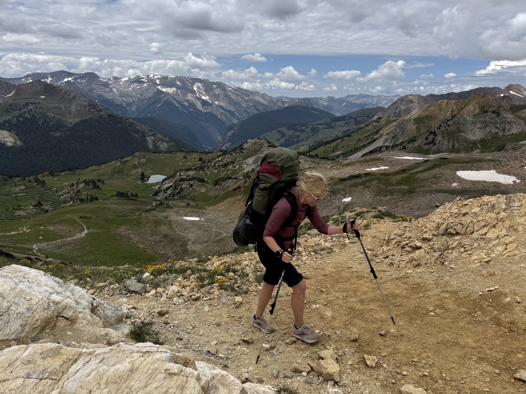 Erica hiking with a backpack in Aspen, Colorado near the Maroon Bells